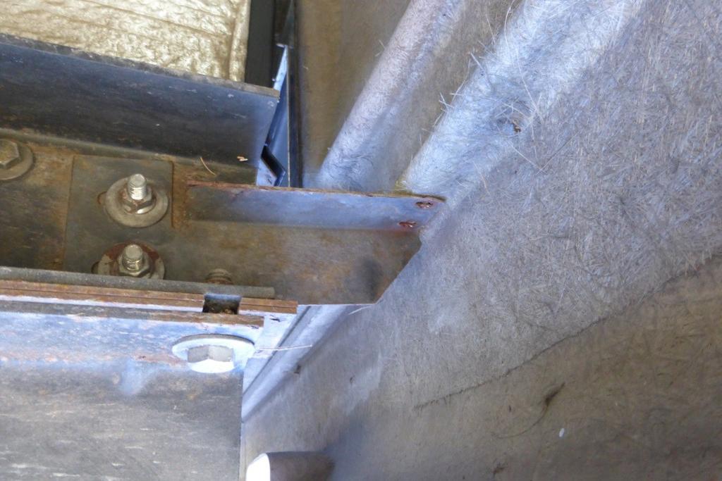 At the end of the frame rails. There are also two screws that hold on the third brake light to a stand-off bracket.