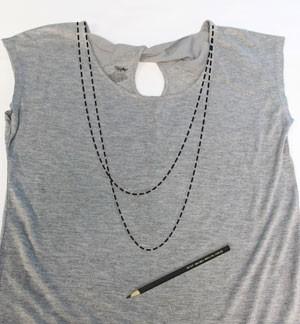 Start by spreading out your tee or tank flat. We need to mark out our draping necklaces so we know where to put our charms.