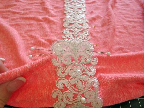 Using your pre-determined top edge placement, and starting at one side seam, pin the narrow lace across both the front and the back of the T-shirt.