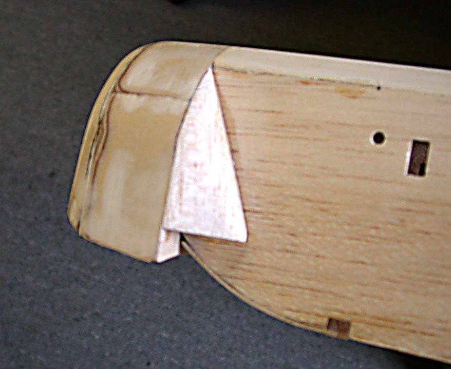 Epoxy the spars to the plywood section that spans the inside of the fuse. This procedure joins the two wing halves together.