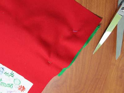 Pin the bow in place. Turn the fabric over to the wrong side and trim the excess bow leaving about 1/4" behind.