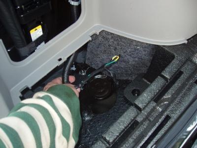 Pull the cover from the spare tire jack area.