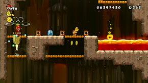 left side of the level over a pit of lava with three