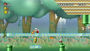 Run towards the row of Piranha Plants on the overhang, duck and hopefully you'll slide through safely. The end of the level is just beyond the Fire Bros.