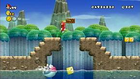 The first coin of the level is in an area that puts you at direct risk from the leaping fish below.