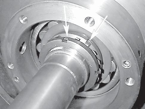 The inner tooth slides in the slot machined into shaft threads. 10. Thread on the remaining large lock nut with the flat side away from the pedestal housing.