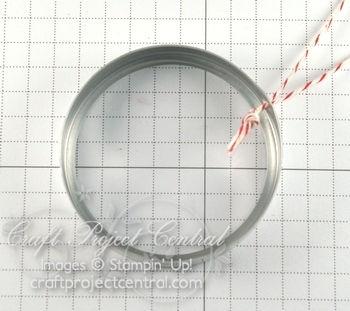 Step 2 Punch a hole with 1/16 Circle punch on top lid of ornament. Attach a 6 piece of Cherry Cobbler Baker s Twine as the hanger.