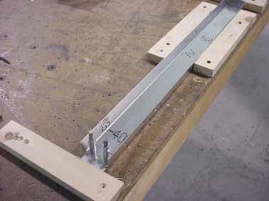 Hold a carpenter square along the edge of the workbench to set the