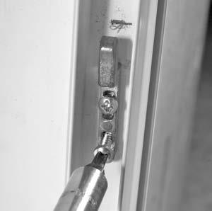 Place a tape measure on the sill track and measure up to the top of the silver lock tab located on the side jamb of the screen door (FIGURE 1).