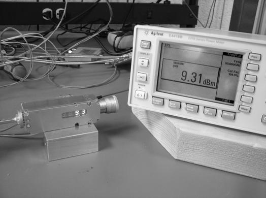 Fig. 10. Measured calibration data and best fit curves for both WR-10 source modules. Fig. 12. Photograph of module A delivering a 9.3 dbm CW tone at 90 GHz, with a power meter for comparison. Fig. 11.