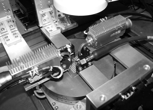 Fig. 14. Photograph of the two multichip modules in use on a probestation for testing a millimeter wave MMIC mixer. much more difficult using currently available laboratory sources.