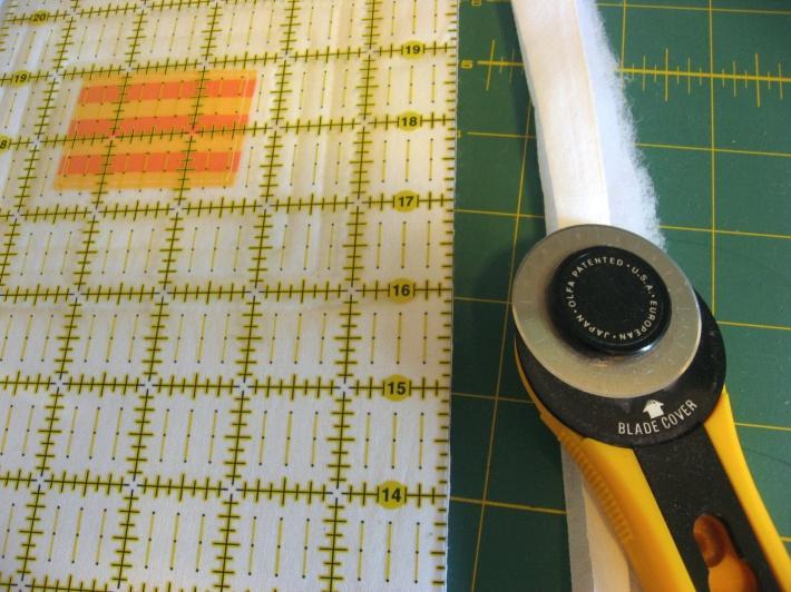 Using a straight edge and rotary cutter, cut your miniquilt to the