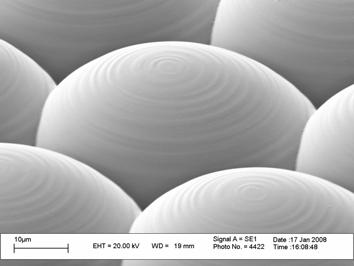 1 Surface roughness Figure 6 shows close-up SEM images of microlenses machined by conventional SIS with forward scanning, and by half-tone SIS, the operating fluence being 200 mj/cm 2 in both cases.
