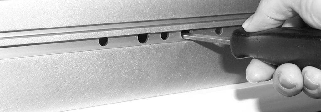 Insert one screw through each of the two slotted holes on the fence mounting bracket and loosely thread on the #10-3 rectangular nuts as shown in Fig.