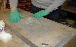 Now use your squeegee to work the resin around until all of the fiberglass cloth is