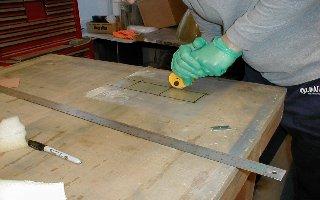 Next use the razor blade to separate the top layer of drop cloth from one of your cut out strips.