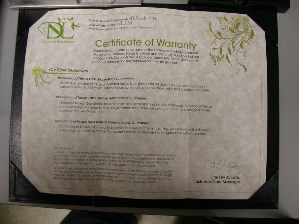 Fig. 2. The Certificate of Warranty and the gemstone in its plastic container are shown.