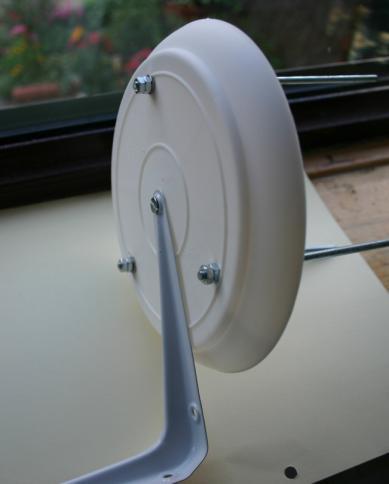 Drill a hole in the centre of the top saucer and use a nut and bolt to attach it to the hanging bracket.