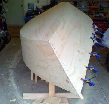 Once the planking is on, the hull starts looking like it is really a boat. Once the epoxy or polyurethane glue sets, the hull becomes rigid and you can loosen or remove it from the strongback jig.