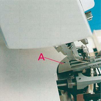 The needle plate 11 is raised out of its mount. The needle plate can be removed to the left.