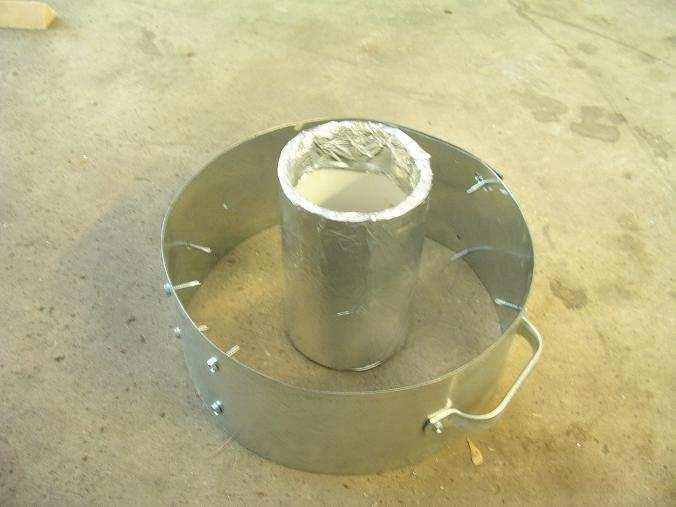sheet metal that was rolled to a 12 inch diameter. There are 2 cheap handles screwed to it. The handles required some field modification to get them to fit the diameter.