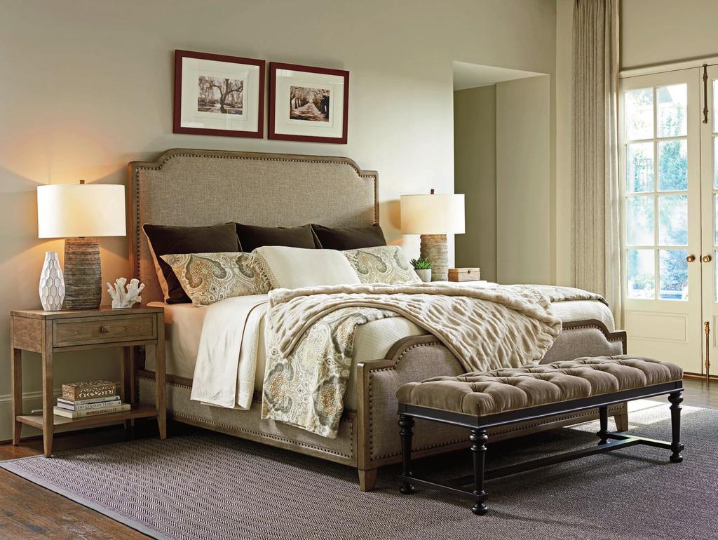 The dramatic Stone Harbour bed features padded upholstered panels on the headboard, footboard and side rails framed with decorative nailhead