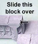 Slide it to the outside so it's flush against the other decorative blocks.