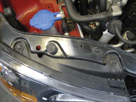 7 7. In order to remove the headlights, use a 10MM socket to remove the two bolts on the top.