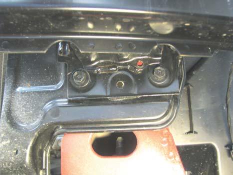 On the back side, use a 10MM wrench to remove the nut holding the headlights.