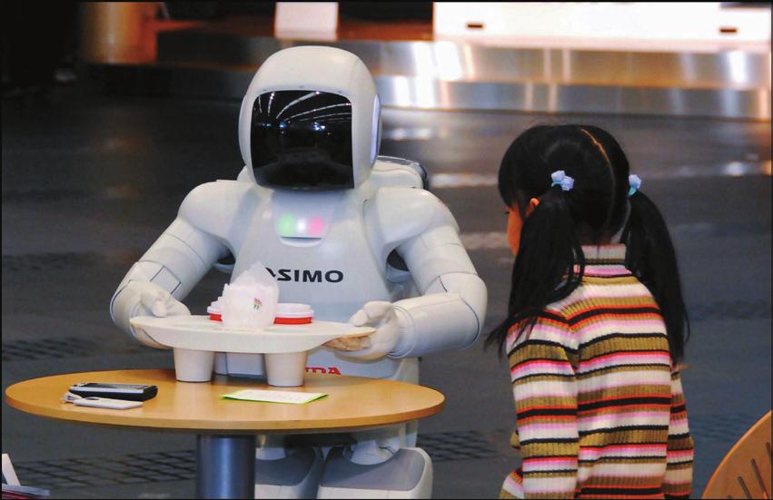 CHAPTER 7 Robots: The Face of the Future An ASIMO robot in Tokyo Prereading Discuss these questions with a partner. 1. Look at the photo.