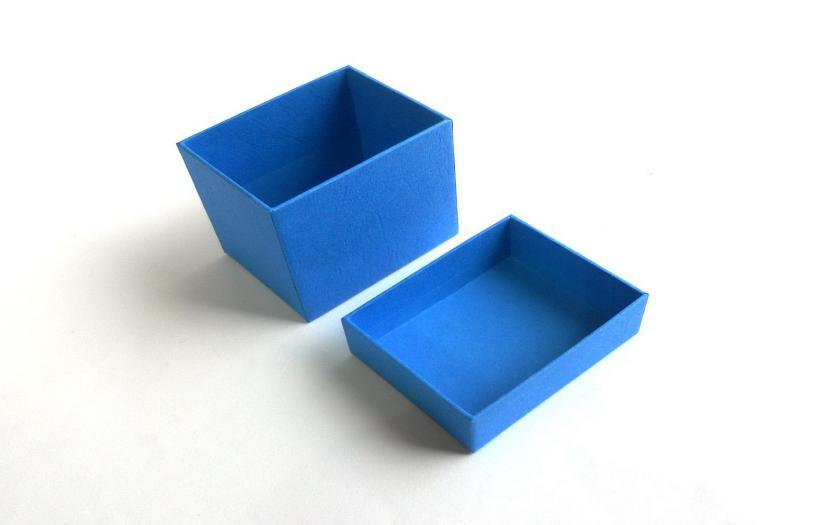Jewelry item placed on foam pad inside a hinged black box, which is then placed inside a 2-piece blue box.