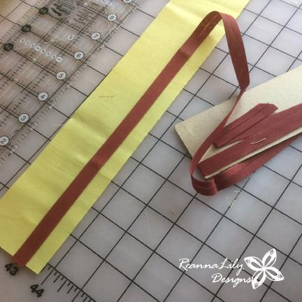 You can measure this the whole length of the border, adding pins and hoping the pins don t cause the trim to skew. OR you can use the 1/2 guide mark on the Seamingly Accurate Seam Guide.
