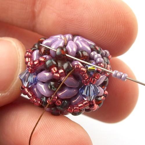 50) Weave through beads to get to the other side of the bead