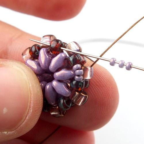 18) Weave through beads to get to one