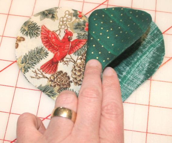 With light heart on top (pair with no leave open lines), stitch on the marked pencil line from center top to center bottom, securing threads at each end by backstitching or tying off. 9.
