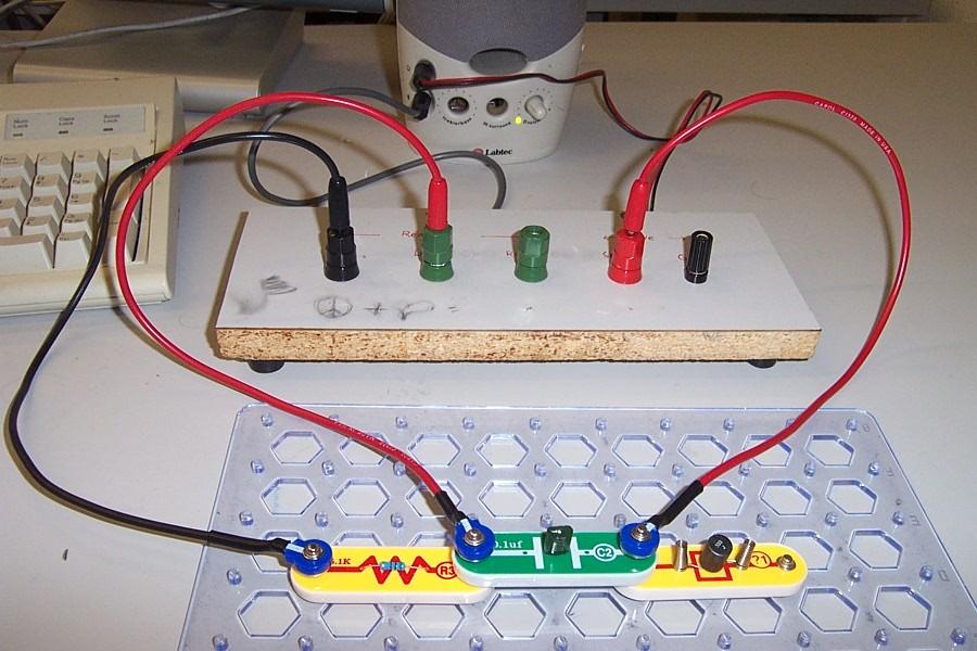 Procedure In between the SnapCircuits board and the PC speakers is the intermediate connection panel (rectangular patch panel with five jacks on top, two cables in the rear). See the photo above.