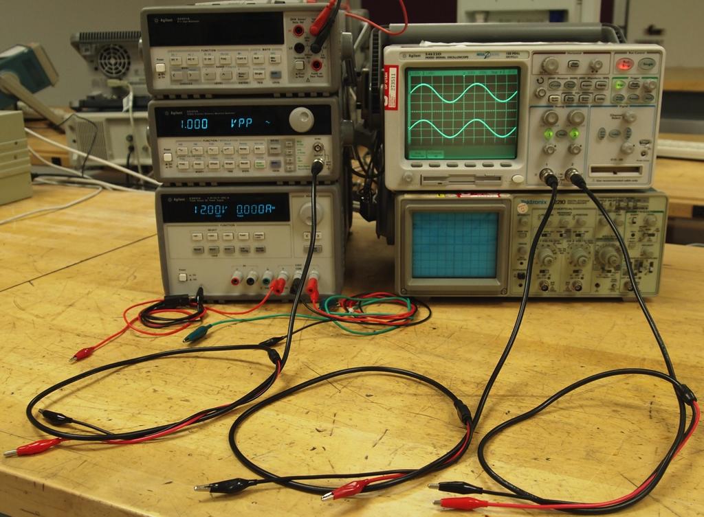 To test the op-amp circuit, you will use a function generator and an oscilloscope. Fig. 7 shows how to connect leads to the function generator and oscilloscope in preparation for making measurements.