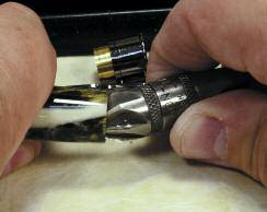 Use a chamfering tool on the inside of the brass tube to break the sharp edge.