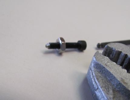 Thread on a 4-40 nut and hold with a vice grip. Spin the bolt against a grinding wheel or belt sander.