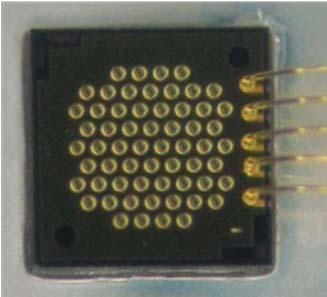 Figure 2. Photo of a VCSEL power array with 60 individual VCSELs. Wirebonds to a package are visible on the right side of the chip. II.