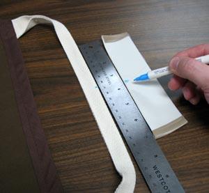 Measure and mark the center of the handles and the center of the vinyl piece (along