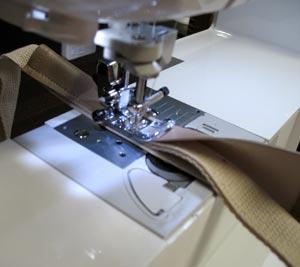 Align the marks together and fold the vinyl around the webbing. Sew a seam along the open edge.