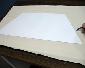 Lay the shape on the lightcolored duck cloth, leaving a few inches of excess fabric around the shape. Trace the shape.