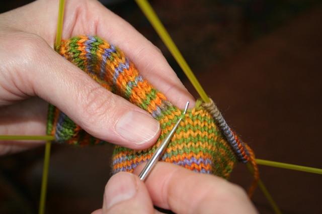 Knit across the 34 stitches of the instep, then pick up the opposite side gusset stitches the same way as the first. If you end up with one more stitch on one side than the other, no worries.