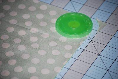 Step Two: Using the 30mm YoYo maker as a guide, cut the four corners so that they are rounded.
