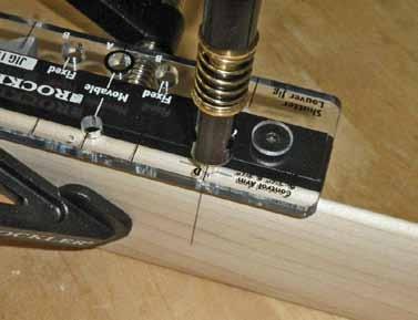 . Align and clamp your louver stock to the Jig () so your center mark lines up with hole D. See Jig Drilling Hole Reference. 3. Drill control arm holes using the 3/3" Shutter Drill Bit (6).