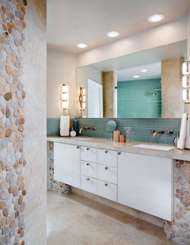 OPPOSITES ATTRACT The unique personalities of Island Stone glass and pebble tiles compliment each other