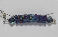 is now exiting the opposite end of the tube. 5)Pick up a 4mm crystal and 3 C beads.