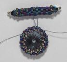 Working around the edge, add one B bead over each exposed thread between your A beads. Weave in your working thread and trim. 7) Remove your stop bead and thread a needle onto your tail thread.