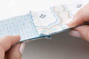 Press the seam allowance toward the darker fabric (2). Repeat to stitch the remaining fabric-a and -B squares to create a second panel.